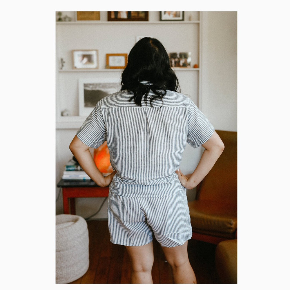 Faith wears a stripped linen short sleeve, size 12, paired with matching Pipit Loungewear Set shorts.