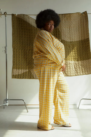Joy-ann (Black Afro hair wearing the orange and grey cotton lawn check PJs) Measurements: She is 5'9" tall 57"/50.5"/55.5" She is wearing a size 28 in both garments. 3 inches of length were added to the hem of her trousers but no other adjustments were made to the pattern.