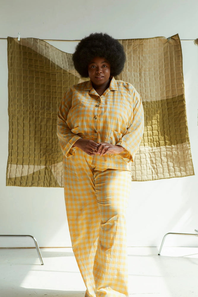 Joy-ann (Black Afro hair wearing the orange and grey cotton lawn check PJs) Measurements: She is 5'9" tall 57"/50.5"/55.5" She is wearing a size 28 in both garments. 3 inches of length were added to the hem of her trousers but no other adjustments were made to the pattern.