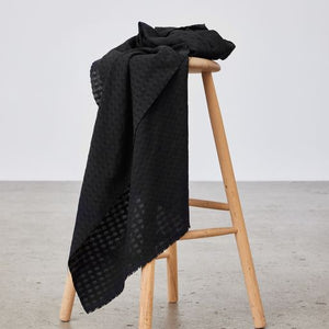 Light and sheer with a fine woven check texture. Black