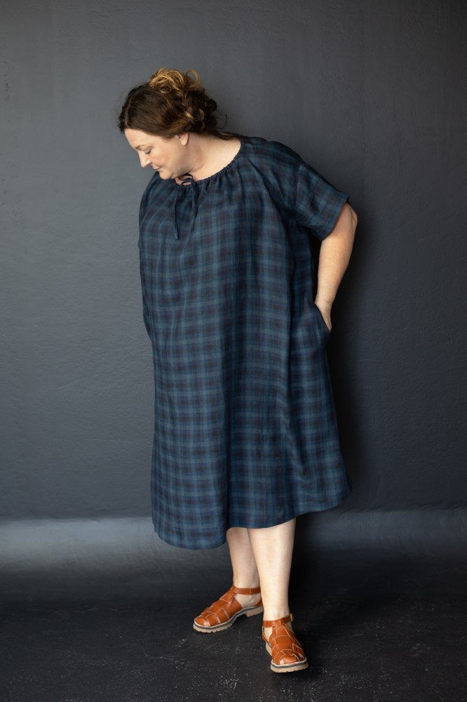 Claire is wearing the Clover dress in All The Blues linen, size extra large.