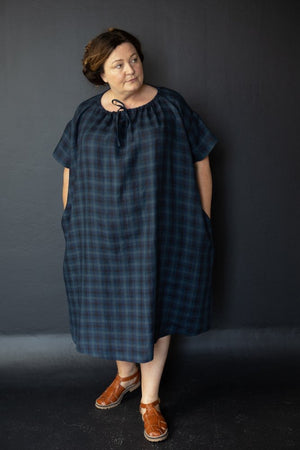Claire is wearing the Clover dress in All The Blues linen, size extra large.