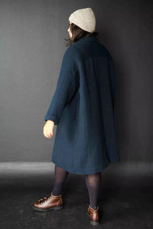 Larli is wearing the Sanda coat in Jacquard Cotton Soft Stitch Navy. Larli is a size 20, and is wearing a size 20. Larli is 5.10. 