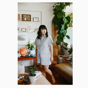  Faith wears a stripped linen short sleeve, size 12, paired with matching Pipit Loungewear Set shorts.