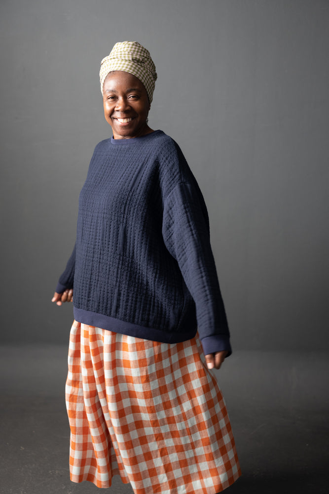 Maxine wears a Sidney in Soft Stitch Navy with True Navy Rib. This is a size 14.