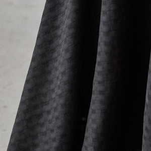 Light and sheer with a fine woven check texture. Black