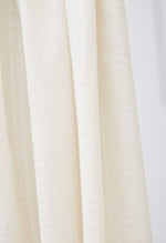 Light and sheer voile with a fine checkered texture. Creamy white